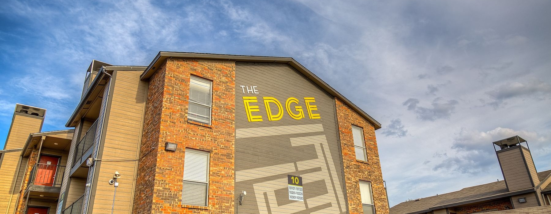 a brick building with a sign on it