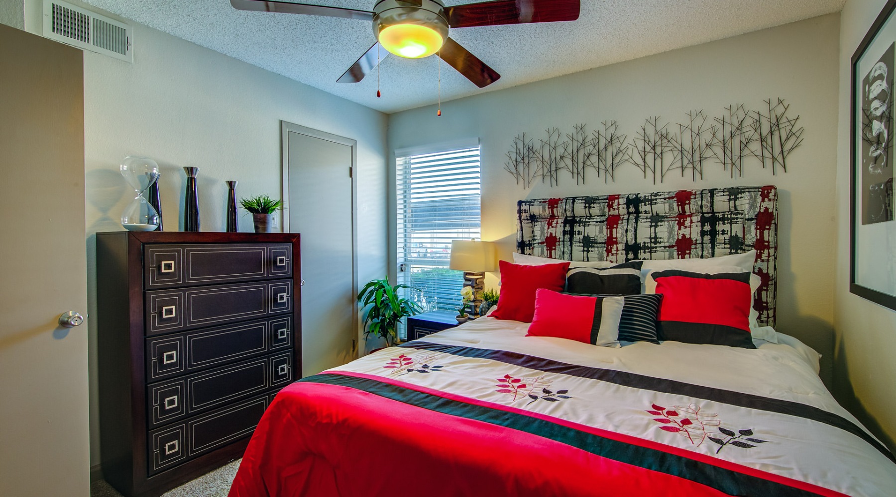 a bedroom with a bed and a dresser