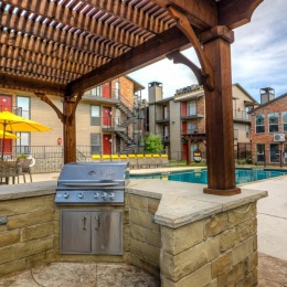 a covered grill area near a pool